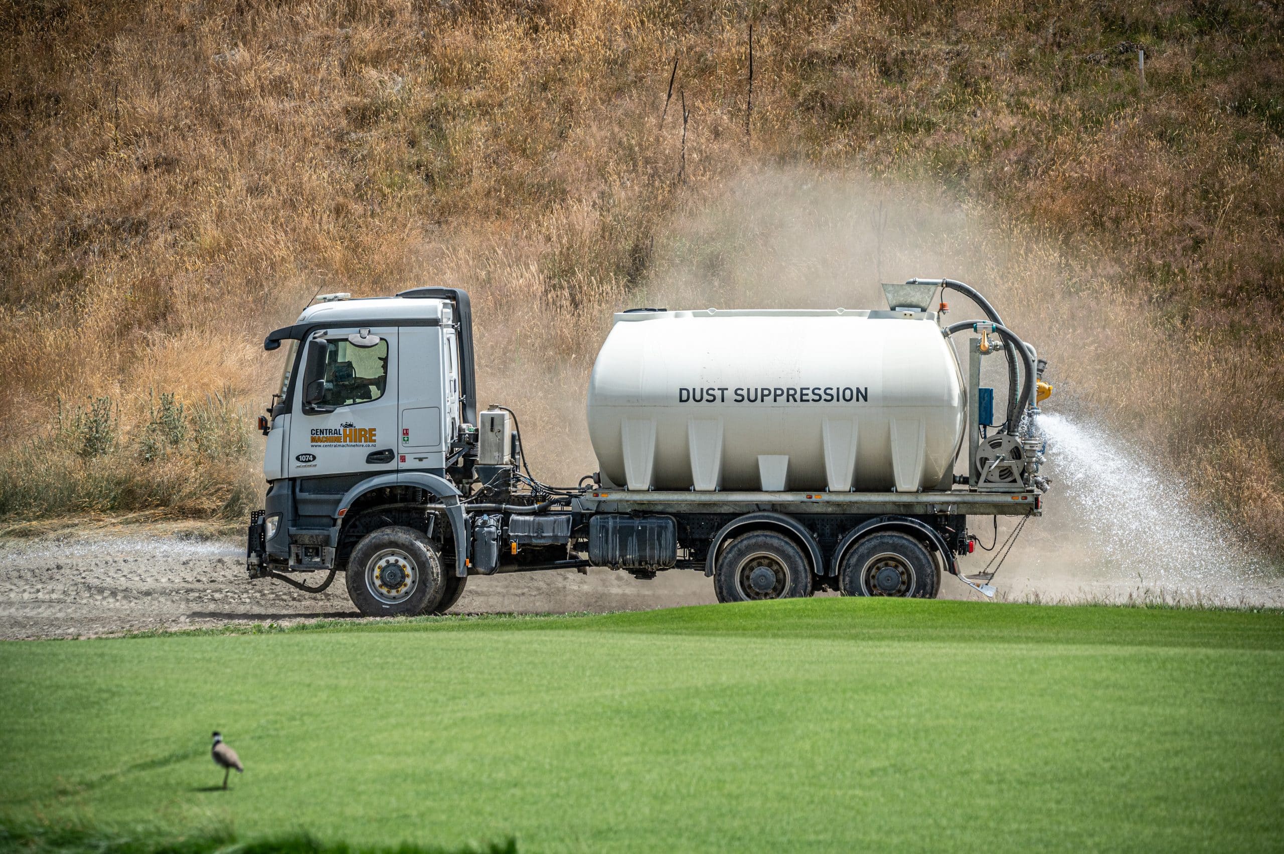 Earthworks water truck keeping golf course site dust free Wanaka